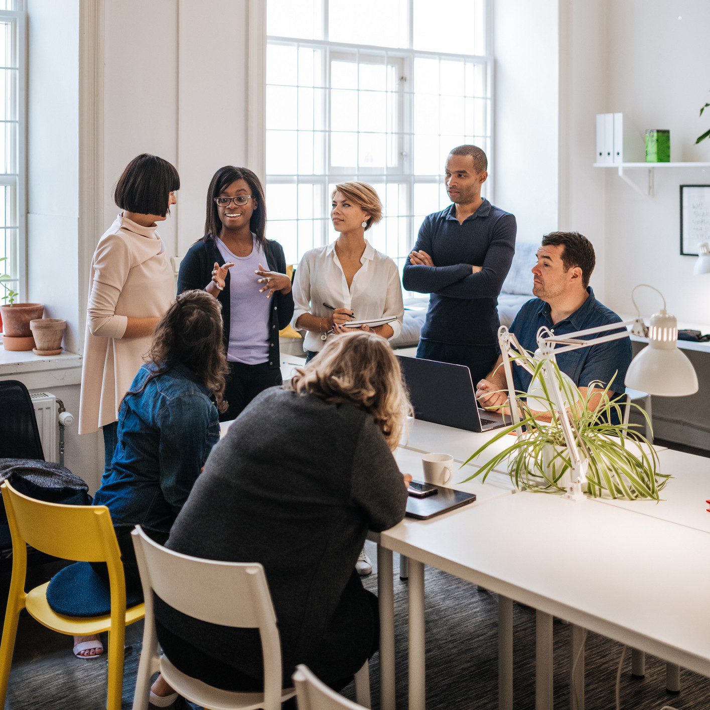 Group discussing in bright office space.