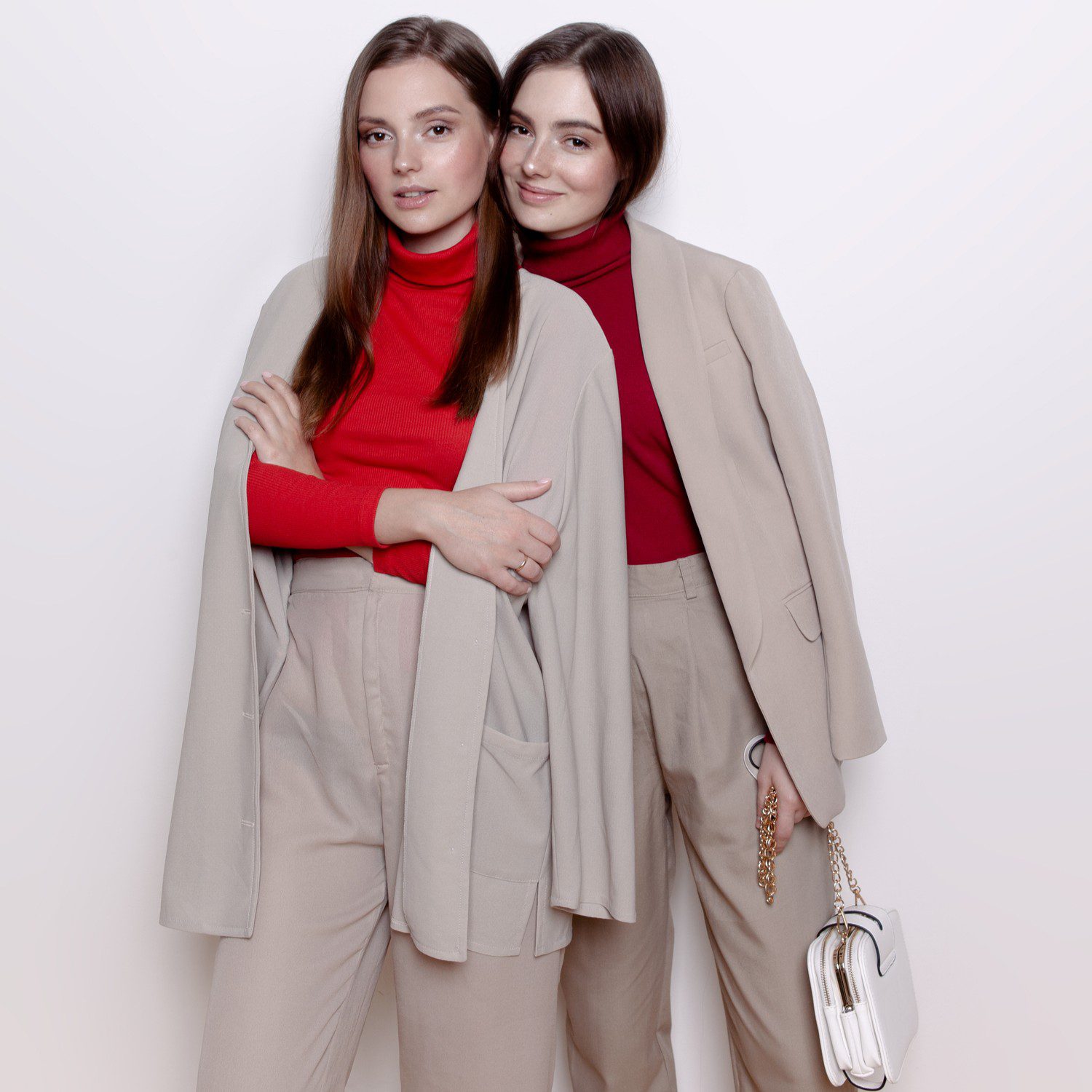Two women in matching beige outfits.