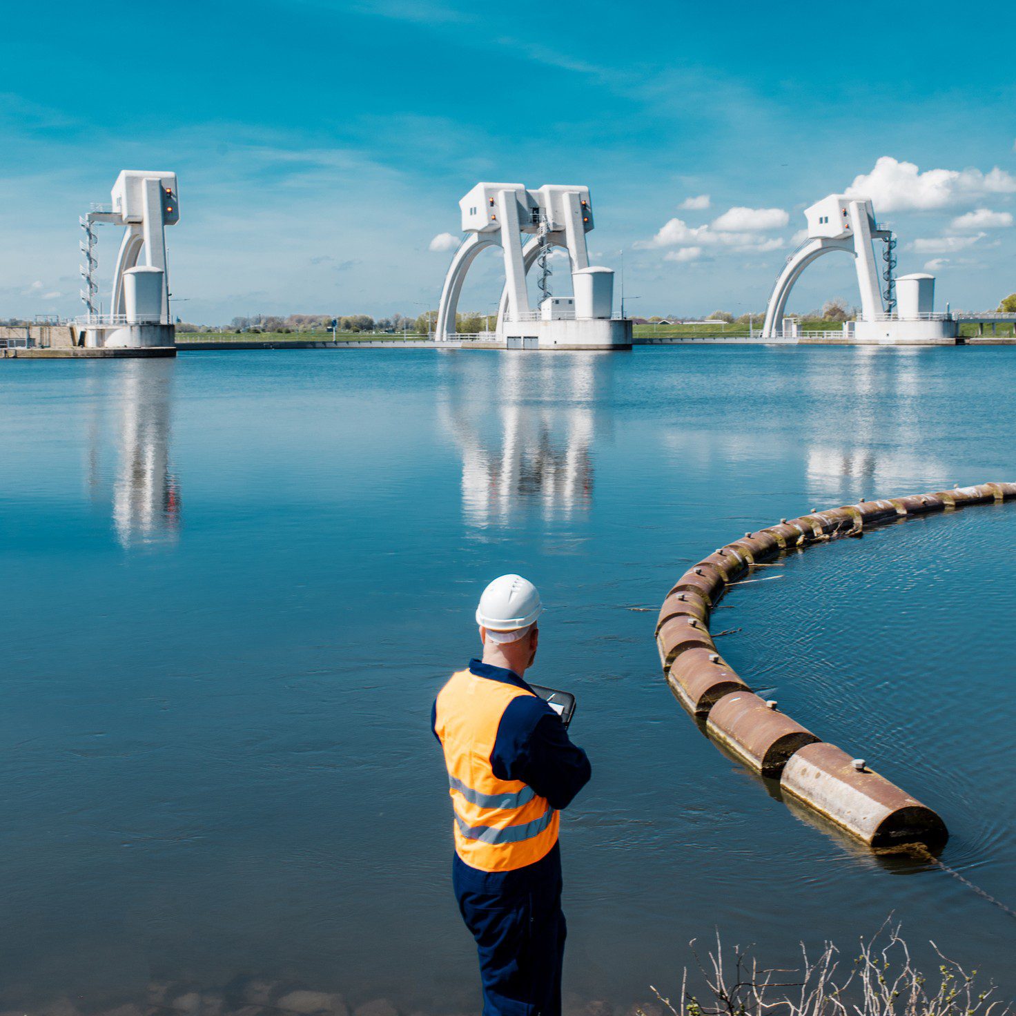 Man observing large water control structures.