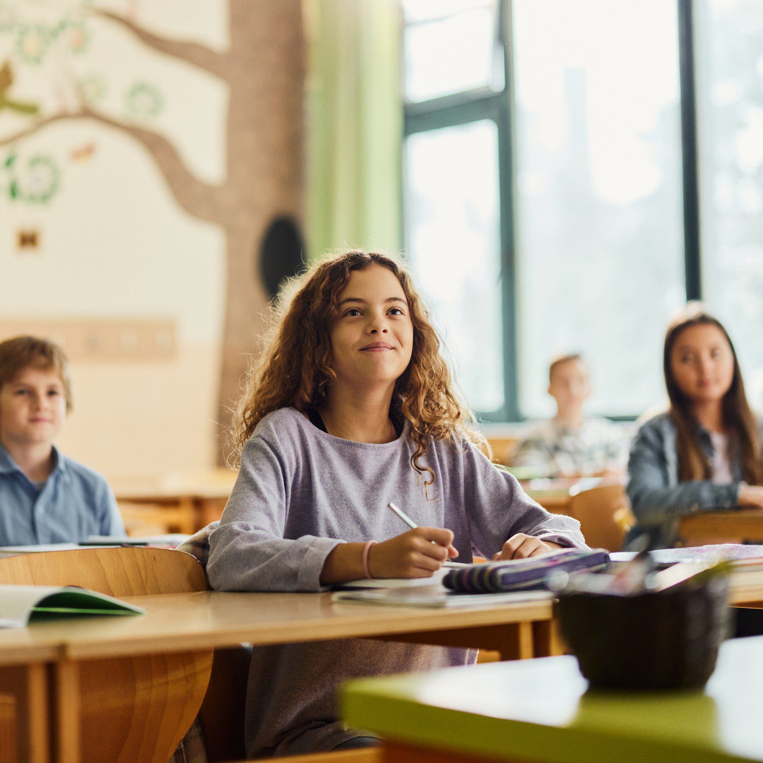 Students attentively listening in a classroom.