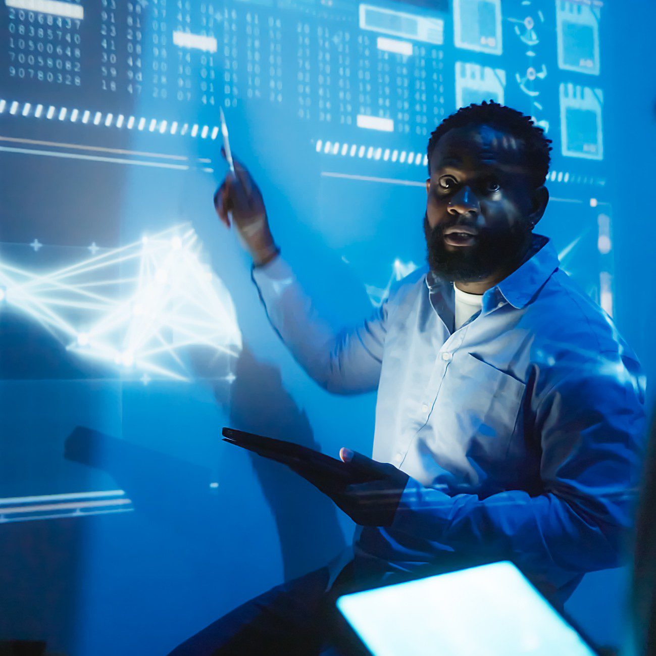 Man presenting data on digital screen.