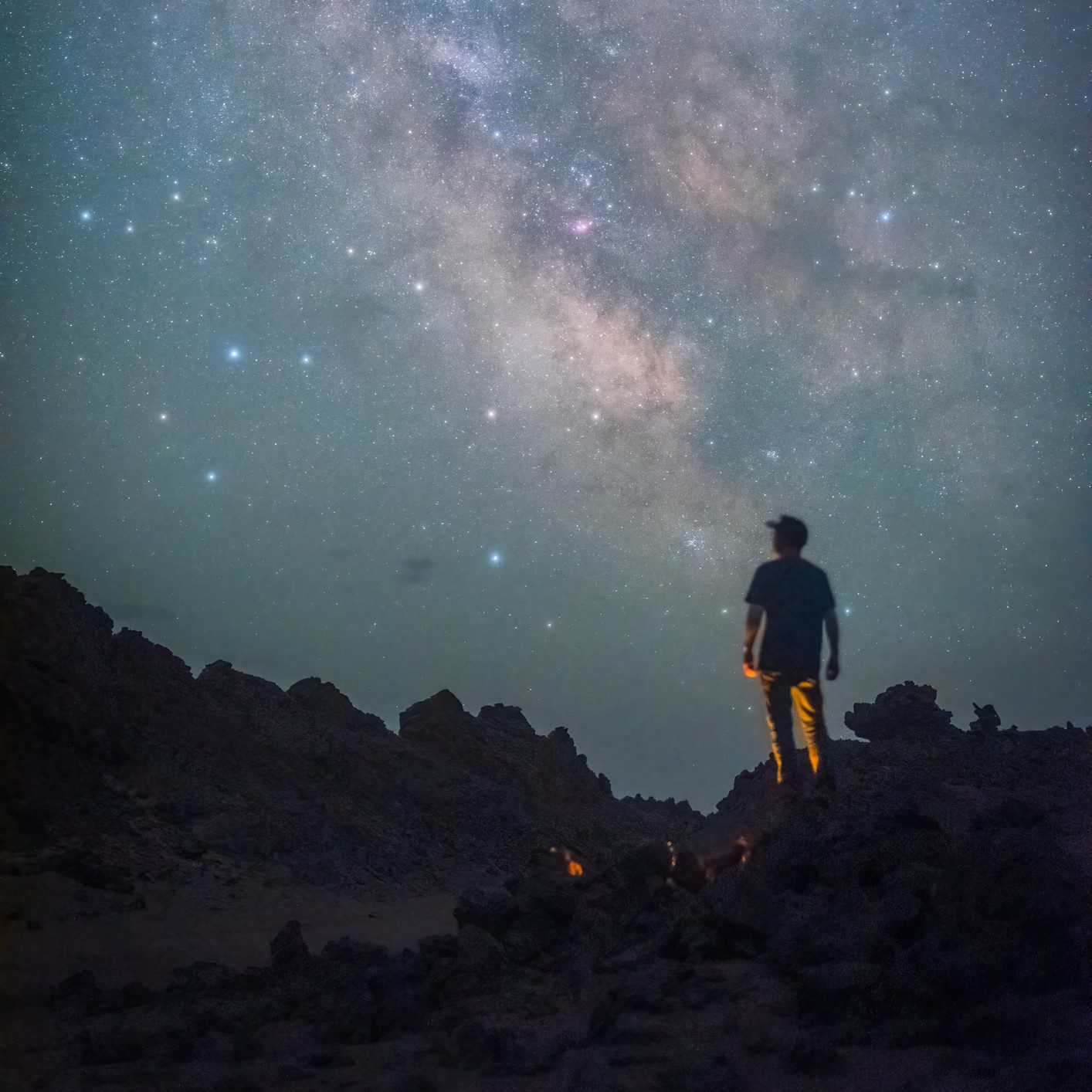 Person stargazing under clear night sky.