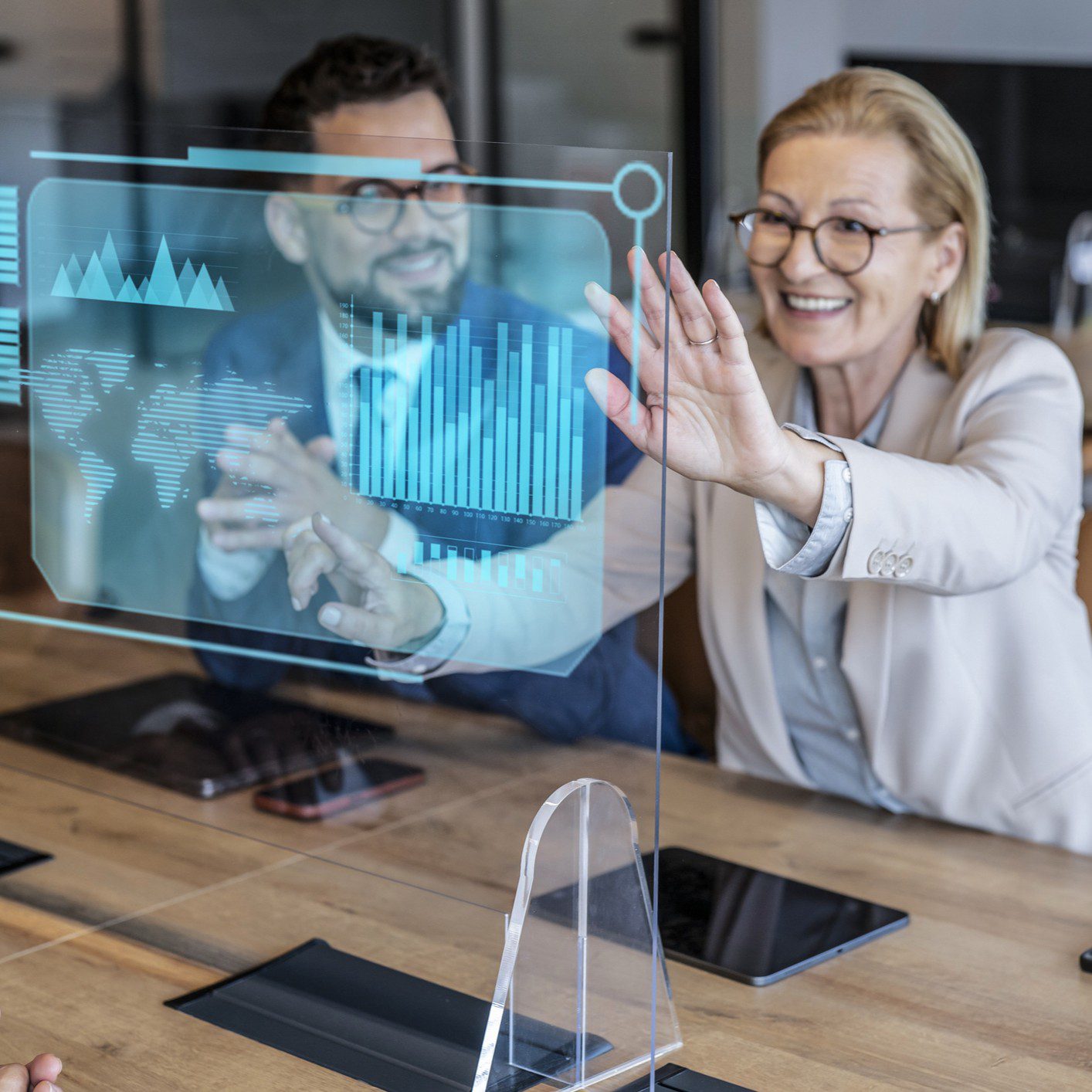 People interacting with futuristic digital display screen.