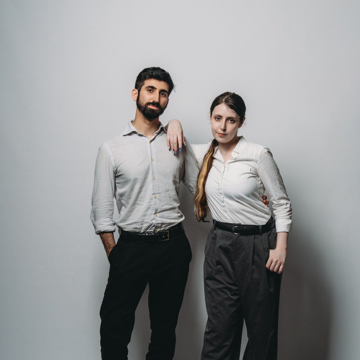 Man and woman posing in formal attire.