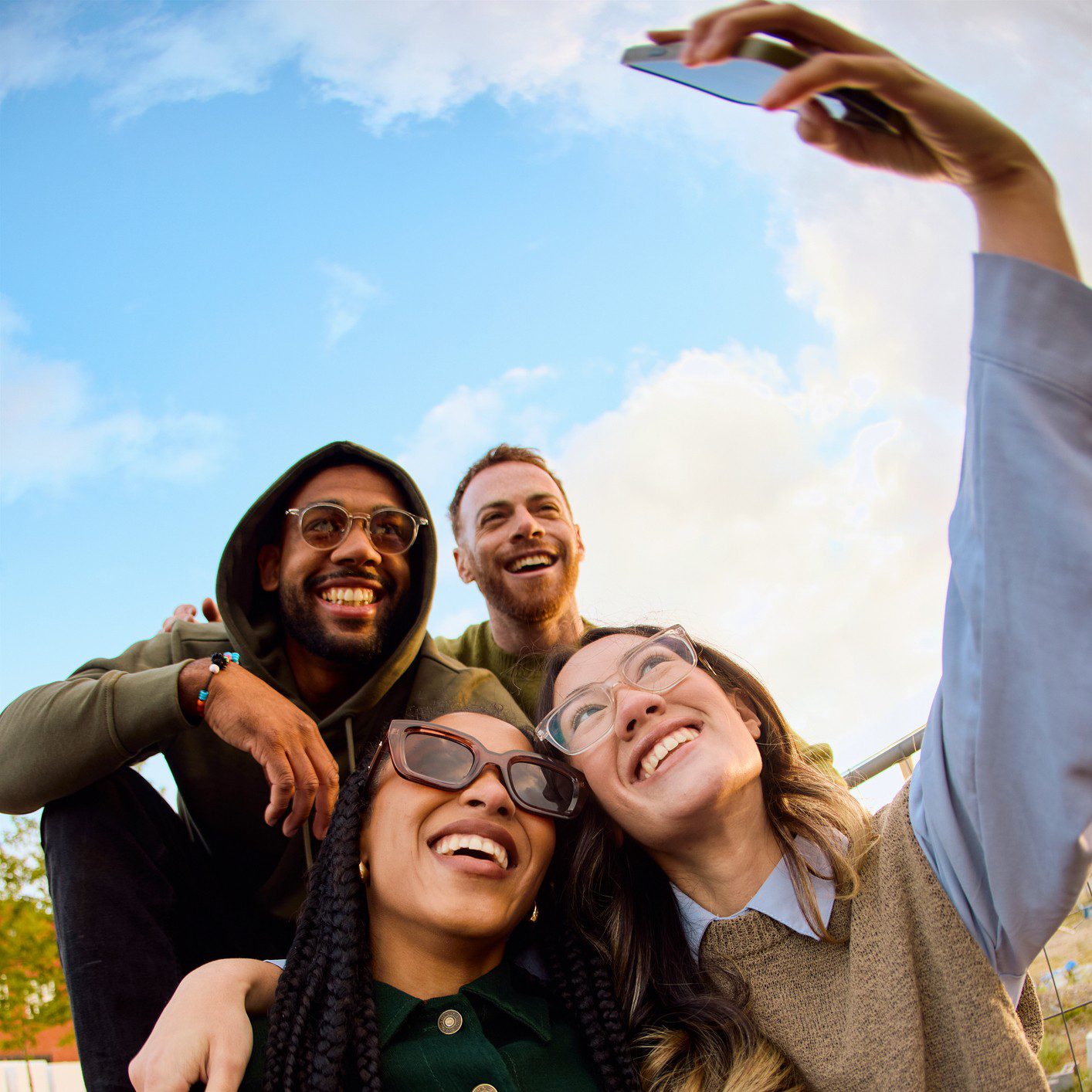 Group of friends taking a selfie outdoors.