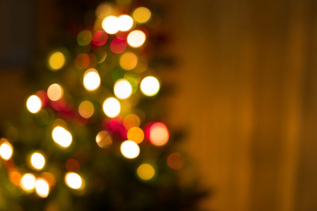 Blurred Christmas tree lights creating a warm festive glow.