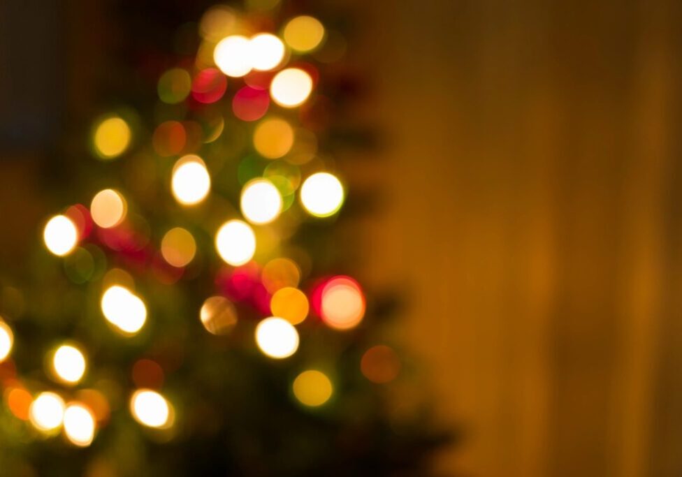 Blurred Christmas tree lights creating a warm festive glow.